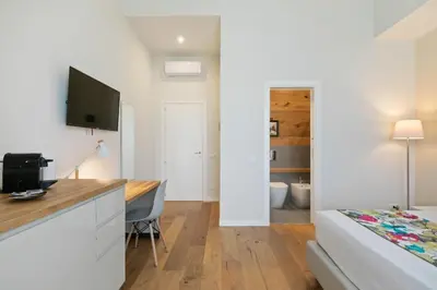 a bedroom with a desk and a bed in a room at GuestHost - NotHotel Palermo Luxury Guest House in Palermo