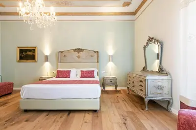 a bedroom with a bed and a mirror and a dresser at GuestHost - NotHotel Palermo Luxury Guest House in Palermo