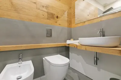 a bathroom with a white toilet and a sink at GuestHost - NotHotel Palermo Luxury Guest House in Palermo