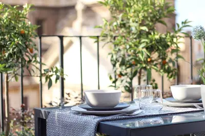 a table with two cups and plates on it at Pànto - Rooftop boutique rooms in Palermo