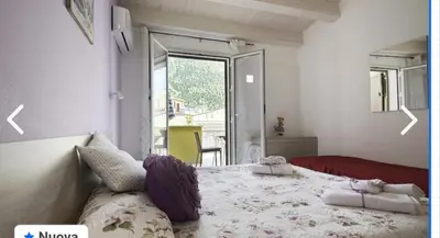 a bedroom with a large bed and a large window at Appartamento francy in Castellammare del Golfo