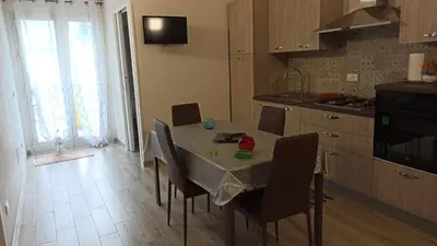 a kitchen with a table and chairs in a kitchen at Appartamento francy in Castellammare del Golfo