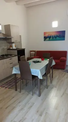 a kitchen and dining room with a table and chairs at Appartamento francy in Castellammare del Golfo