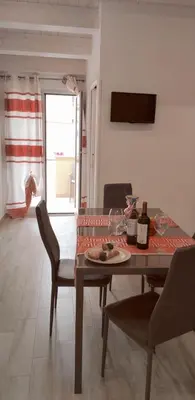 a dining room with a table and chairs with wine glasses at Appartamento francy in Castellammare del Golfo