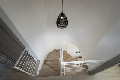 a staircase with a pendant light and a white stair case at Giardino degli Allori - Villa Flores in Castellammare del Golfo
