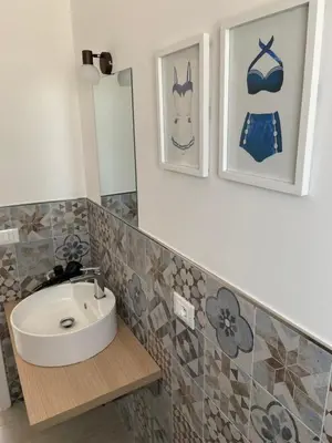 a bathroom with a sink and a mirror at Villa Costanza in San Vito lo Capo
