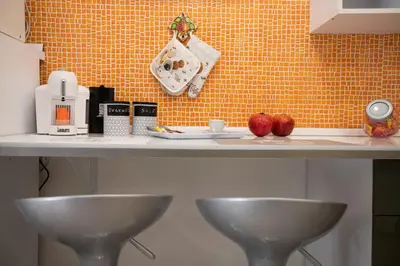 a kitchen counter with two bowls and apples on it at La casa di Nana’ locazione turistica in Palermo