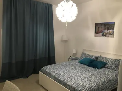 a bedroom with a bed and a chandelier at La casa di Nana’ locazione turistica in Palermo