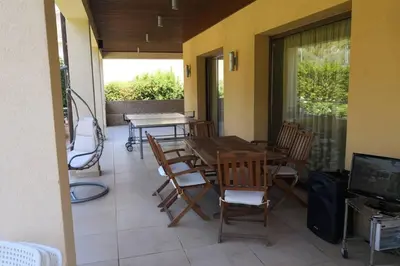 a patio with a table and chairs and a television at Villa Tiziana in Monreale