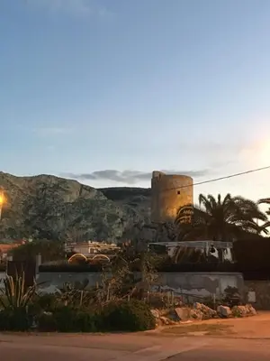 a view of a city with a castle in the distance at Casa Vacanza La Isla Bonita in Isola delle Femmine