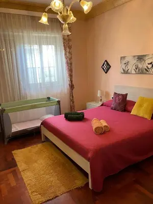 a bedroom with a large bed with a red blanket at Casa Vacanza La Isla Bonita in Isola delle Femmine