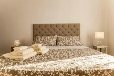 a bedroom with a bed with towels on it at Villa Bienvenue in Carini