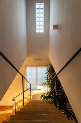 a staircase with a window and a plant at Villa Bienvenue in Carini