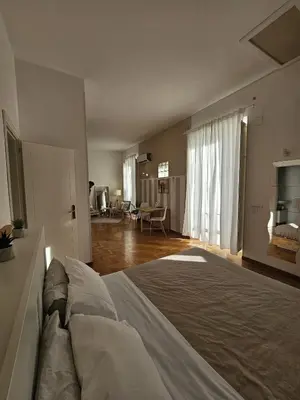 a bedroom with a bed and a living room at Suite Cathedral Palermo in Palermo