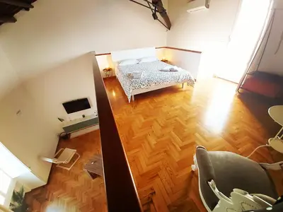 an overhead view of a bedroom with a bed and wooden floors at Suite Cathedral Palermo in Palermo