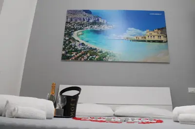 a bedroom with a bed with a picture on the wall at Rigoletto Holiday Home,Centrocittà Palermo in Palermo
