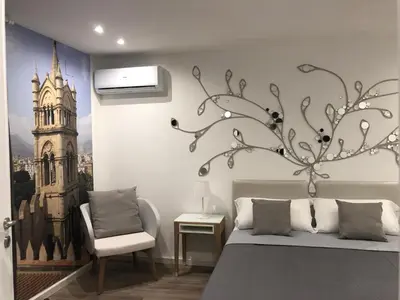 a bedroom with a bed with a wall mural of a church at SUITE 4 CANTI in Palermo
