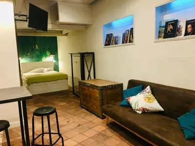 a living room with a couch and a bed at ne mia in Palermo