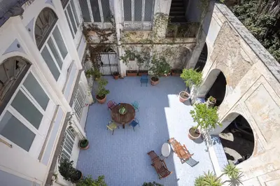 an overhead view of a courtyard with a table and chairs at Dietro San Domenico Apartment in Palermo