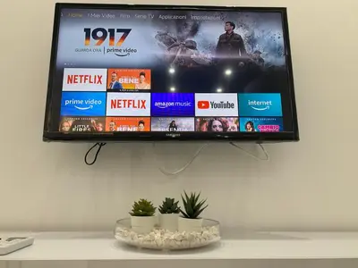 a flat screen tv hanging on a wall at Rossella’s home in Palermo
