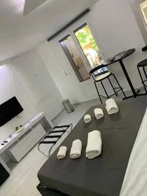 a room with a bed with four white pillows at Rossella’s home in Palermo