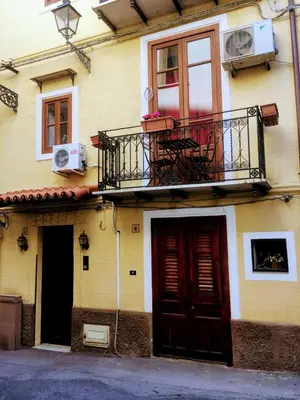 a building with two doors and a balcony on it at Home Casa Professa 1 in Palermo