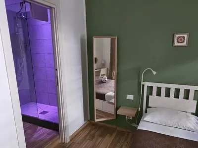 a bedroom with a shower and a mirror at Teatro Del Sole Apartment in Palermo