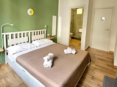 a bedroom with a large bed with towels on it at Teatro Del Sole Apartment in Palermo