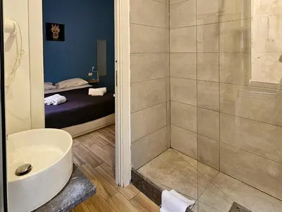 a bathroom with a shower and a toilet and a sink at Teatro Del Sole Apartment in Palermo