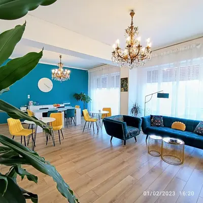 a living room with blue walls and a blue couch and chairs at B&B Be Home in Palermo