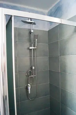 a shower with a shower head in a bathroom at Le case di Ninni - Monfenera in Palermo