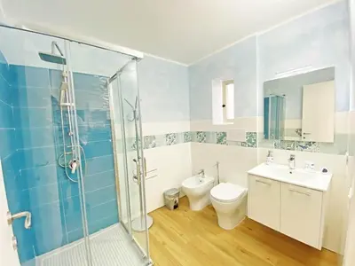 a bathroom with a shower and a toilet and a sink at Le case di Ninni - Monfenera in Palermo