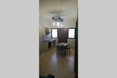 a kitchen and dining room with a table and chairs at Isabella house in Casteldaccia