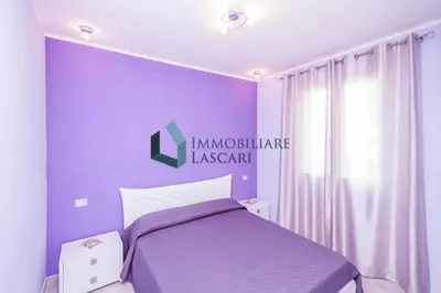 a purple bedroom with a bed and a window at Villa Luana, a pochi passi dal mare in Lascari