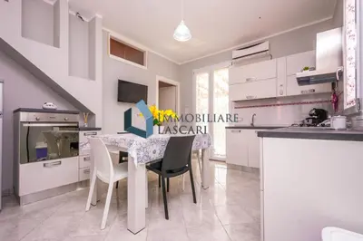 a kitchen with a table and chairs in a room at Villa Luana, a pochi passi dal mare in Lascari