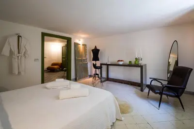 a bedroom with a bed and a table and chairs at Surplus Charming Apartment in Palermo