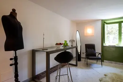a dressing room with a table and a chair at Surplus Charming Apartment in Palermo