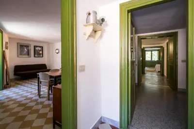 a hallway with a green door and a living room at Surplus Charming Apartment in Palermo