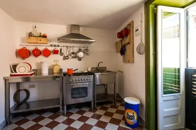 a small kitchen with a stove and a sink at Surplus Charming Apartment in Palermo