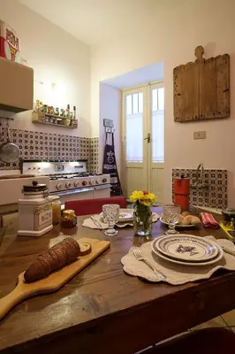 a kitchen with a wooden table with food on it at Casa Particular Luxury in Palermo