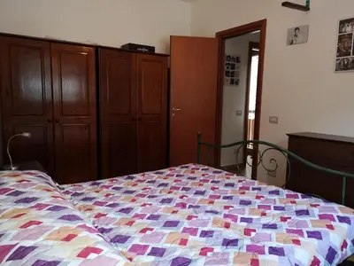 a bedroom with a bed with a colorful quilt at La Casetta della Musica in Mondello