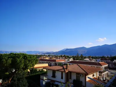 a view of a city with mountains in the background at La Casetta della Musica in Mondello