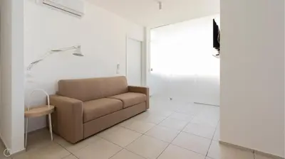 a living room with a couch and a table at Visitsicilia Azzurra Mare in Alcamo Marina