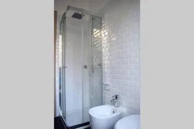 a bathroom with a shower and a toilet and a sink at 29/4 Exclusive Suite tra Teatro Massimo e Porto in Palermo