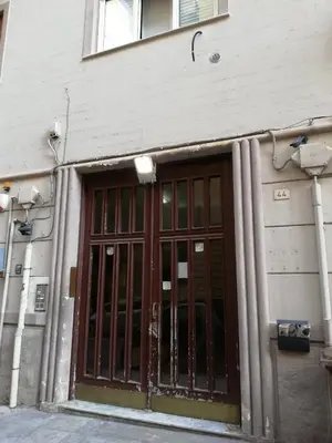 an entrance to a building with a large door at 29/4 Exclusive Suite tra Teatro Massimo e Porto in Palermo