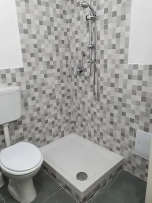 a bathroom with a shower with a toilet and a sink at Alle Porte del Capo in Palermo