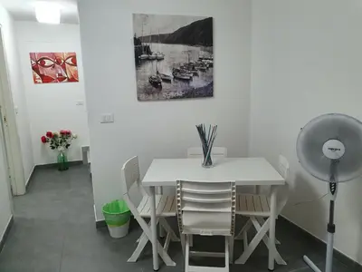 a dining room with a white table and chairs at Alle Porte del Capo in Palermo