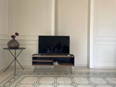 a living room with a flat screen tv on a wall at BARRIQUE Guest House in Palermo