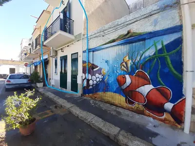 a mural of a fish on the side of a building at La Casetta sul Mare in Isola delle Femmine