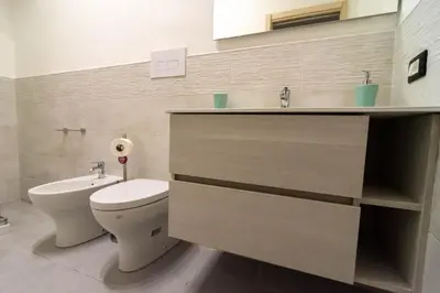 a bathroom with a toilet and a sink at La Casetta sul Mare in Isola delle Femmine